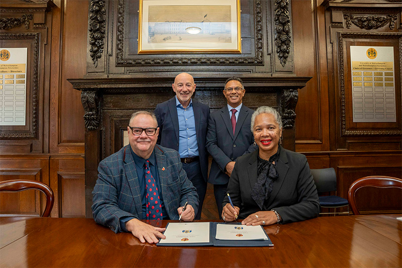 (L-R): Front - Councillor Stephen Simkins, City of Wolverhampton Council Leader, and Angela Spence, University of Wolverhampton Chair of the Board of Governors, signing the Civic University Agreement at the Wulfruna Building. Back - Tim Johnson, City of Wolverhampton Council Chief Executive, and Professor Ebrahim Adia, University of Wolverhampton Vice Chancellor and Chief Executive