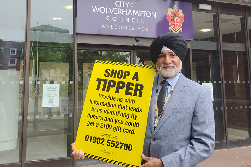 Councillor Bhupinder Gakhal, cabinet member for resident services, with Shop a Tipper information