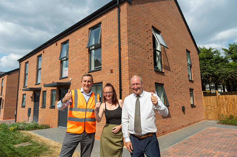 Gavin Ward, Morro Partnerships West Midlands Operations Director (left), and Councillor Steve Evans, City of Wolverhampton Council Deputy Leader and Cabinet Member for City Housing and Assets (right), with Lucy Whetton, resident (centre) outside her new council home in Waveney Gardens, Penn
